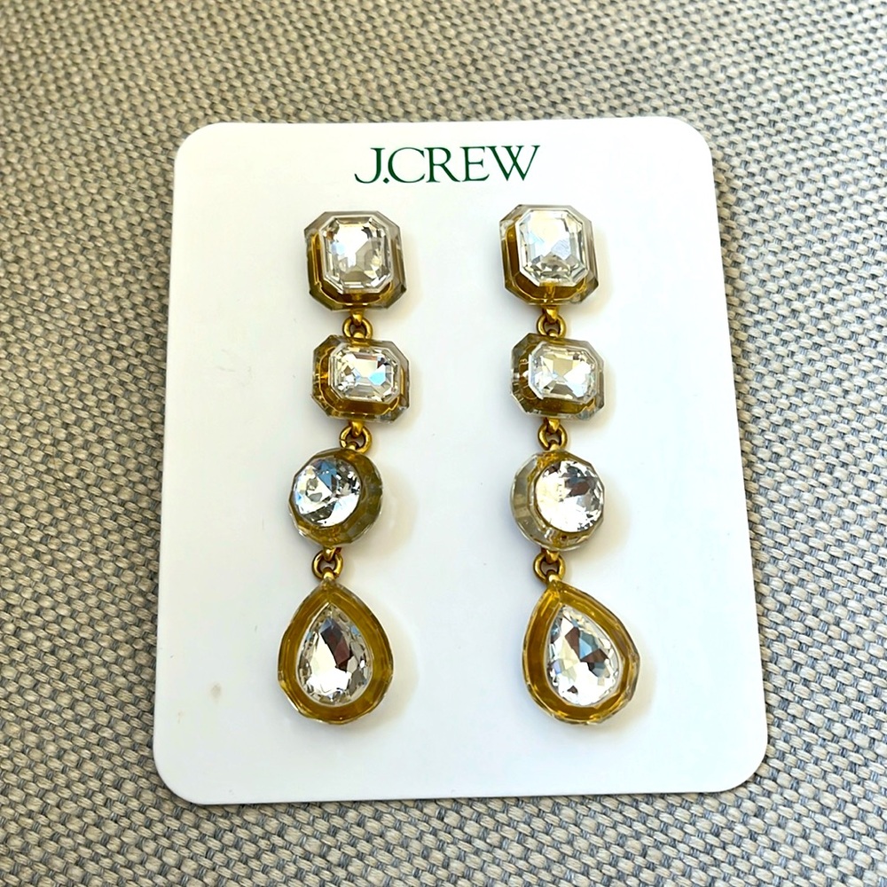 Long hanging earrings with gold and silver details.